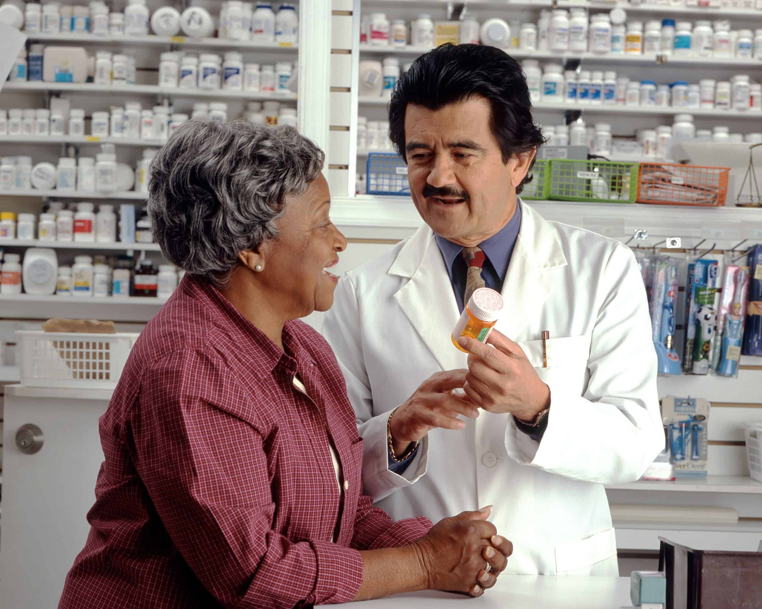 Pharmacy explaining to a customer how to use their prescription